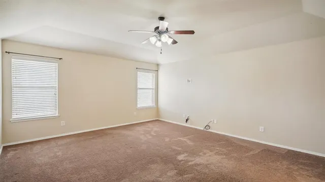 a view of a chandelier fan and a refrigerator in a room