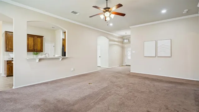 a view of a livingroom with a chandelier fan