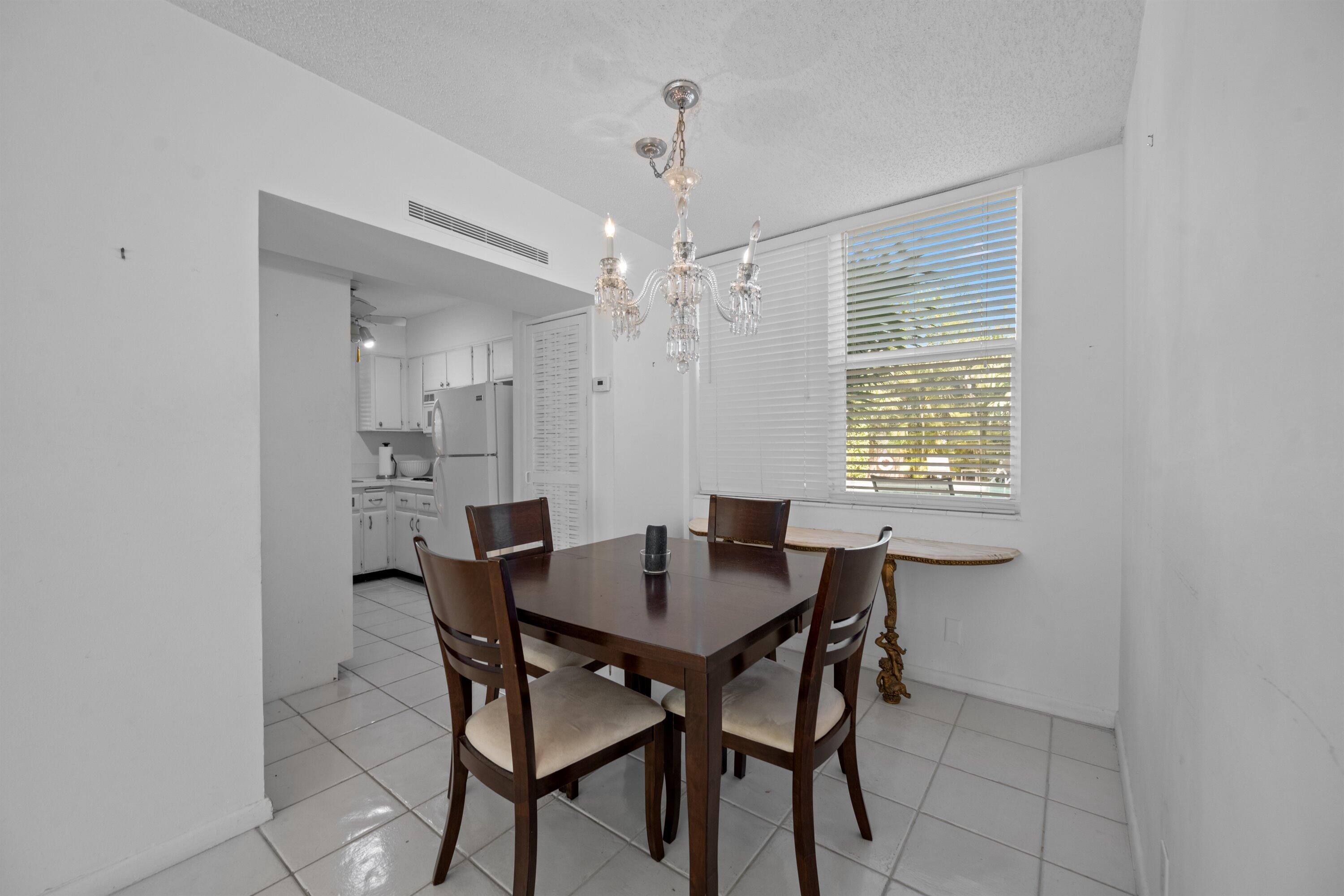 401 Peruvian Avenue, Unit 1010 Palm Beach, FL 33480 - Photo 4 of 19 a view of a dining room with furniture and window