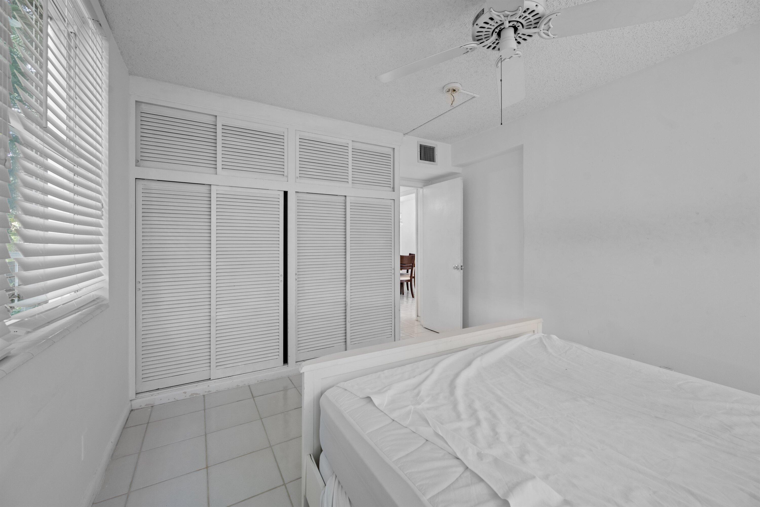 401 Peruvian Avenue, Unit 1010 Palm Beach, FL 33480 - Photo 9 of 19 a bedroom with a bed and a window