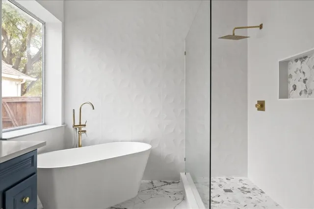 a bathroom with a bathtub and a window