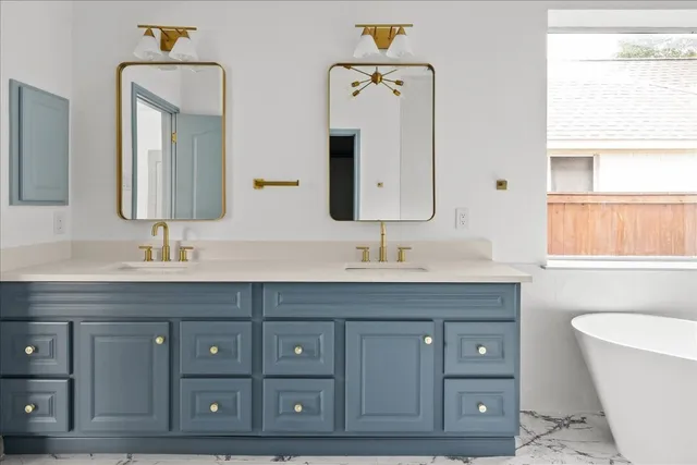 a spacious bathroom with a double vanity sink and a mirror