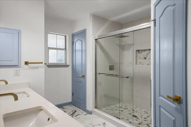 a bathroom with a shower and a sink