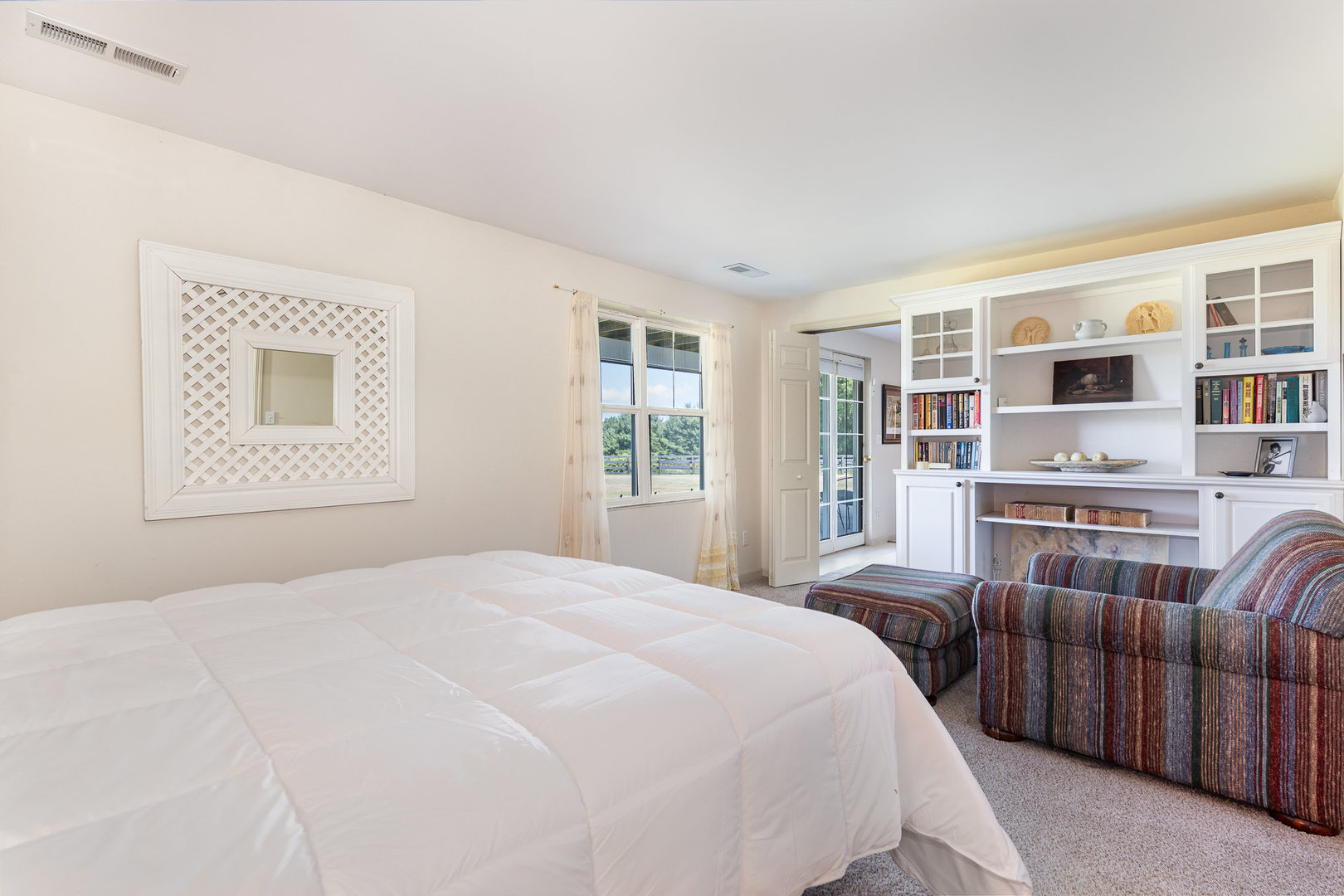 5284 Harvey Road Caledonia, IL 61011 - Photo 38 of 60 a bedroom with a large bed a flat tv screen and next to a window