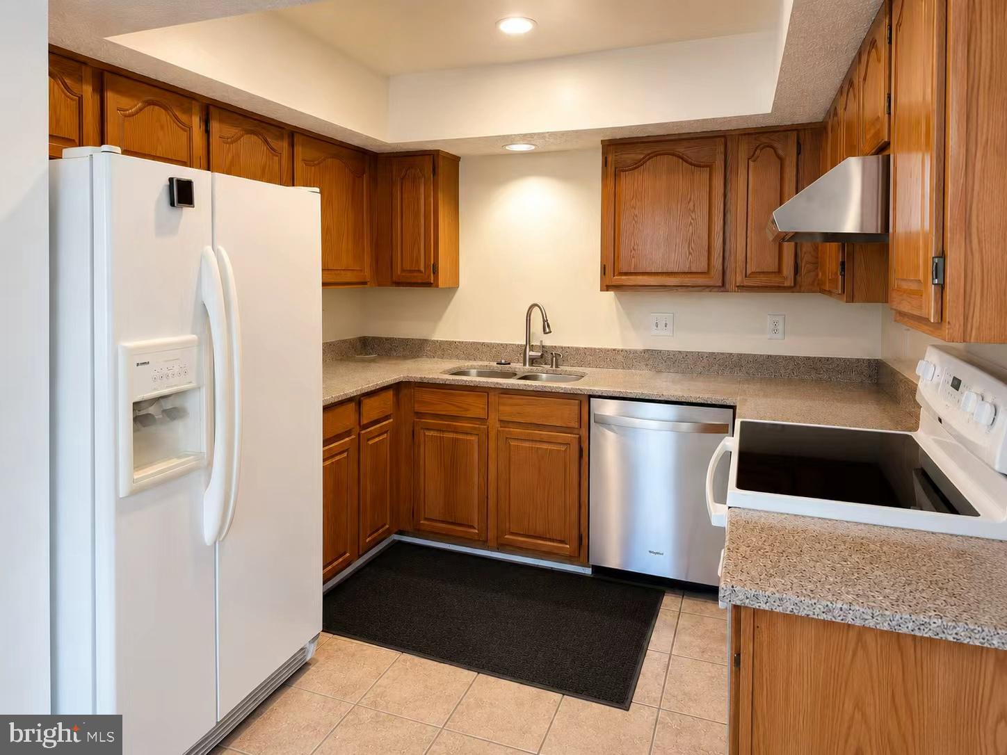 13336 Burkitts Road Fairfax, VA 22033 - Photo 3 of 14 a kitchen with a refrigerator sink and cabinets
