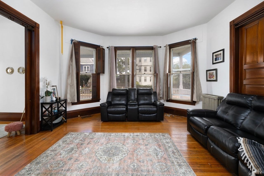 311 Elm Street Woonsocket, RI 02895 - Photo 12 of 29 a living room with furniture fireplace and a large window