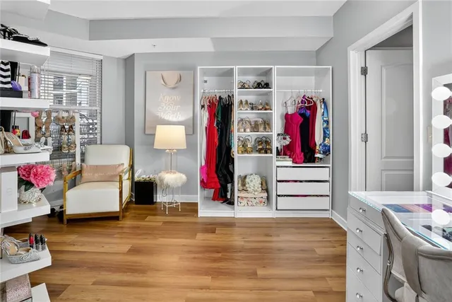 a view of walk in closet with clothes and shoes