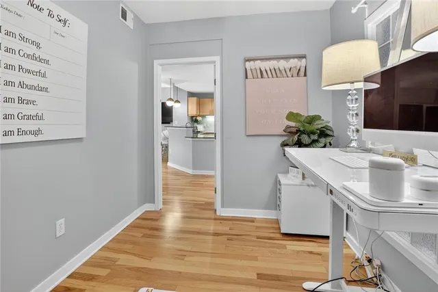 a hallway with dining room and wooden floor