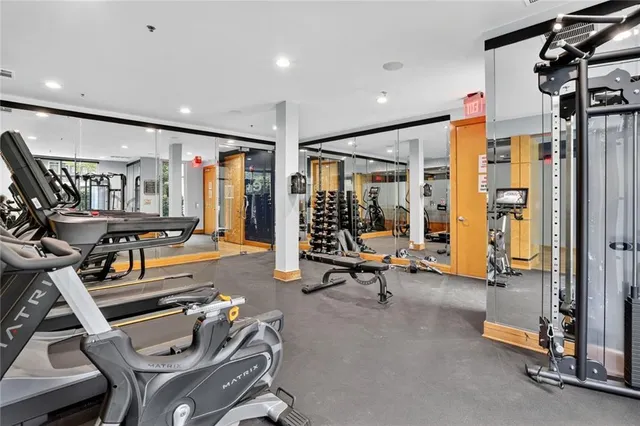 a gym room with lots of gym equipment