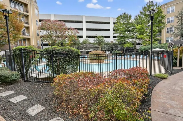 a view of a house with a small yard and wooden fence