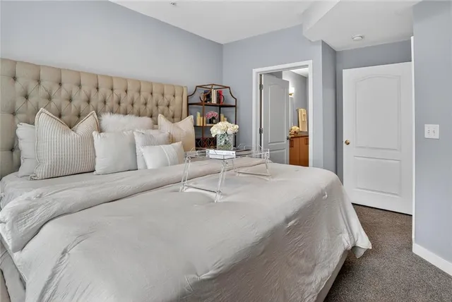 a bedroom with a bed and a mirror