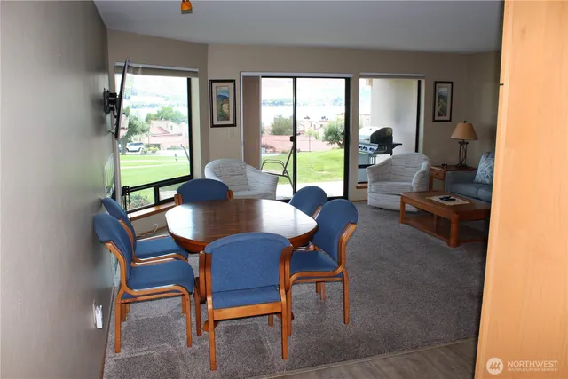a view of a dining room with furniture large windows and wooden floor