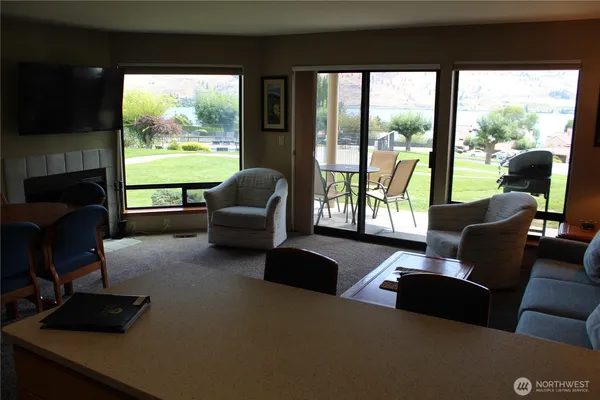a living room with furniture and a floor to ceiling window