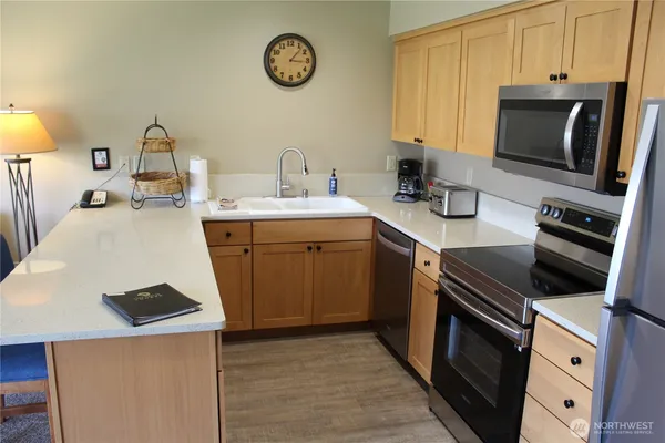a kitchen with a sink stove and microwave