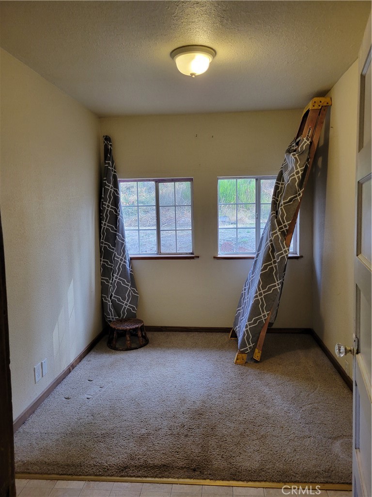 300 Bald Rock Road Berry Creek, CA 95916 - Photo 27 of 45 an empty room with windows