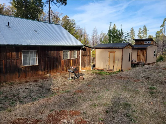 a view of a fire pit with large trees
