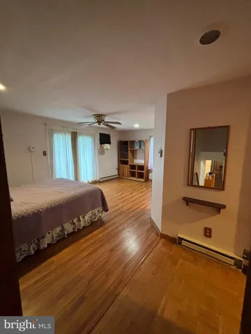 a spacious bedroom with a bed and a table in it