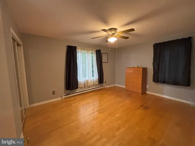 a view of an empty room with a ceiling fan