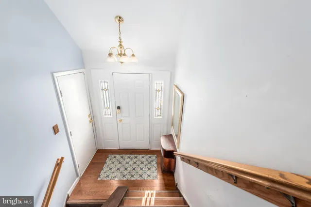 a bathroom with a sink a toilet a mirror and shower
