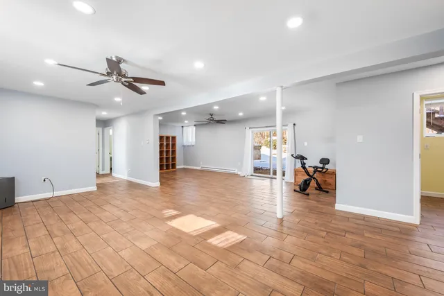 a view of a livingroom with a stove and cabinets