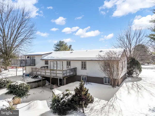 a view of a house with a wooden fence