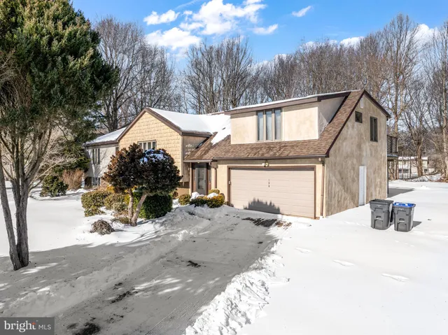 a view of a house with a yard covered in snow