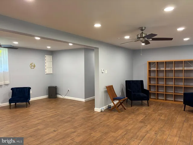 a view of a livingroom with workspace and a window