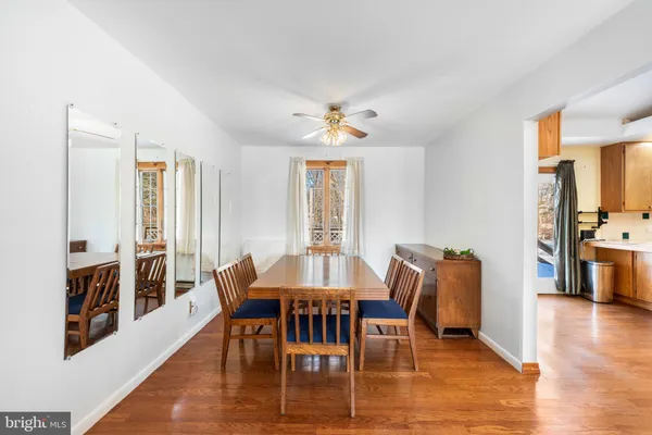 a view of a a dining room with furniture window and wooden floor