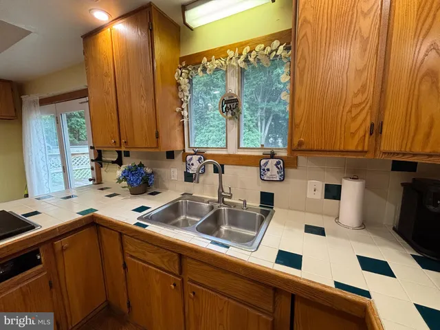 a kitchen with a sink a stove and cabinets