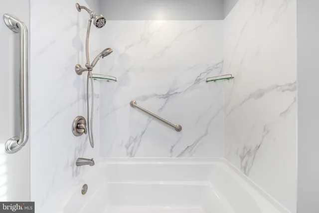 a bathroom with a shower and a bath tub