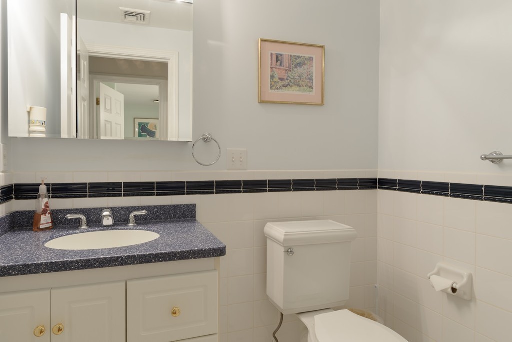 35 Norwich Road Wellesley, MA 02481 - Photo 20 of 25 a bathroom with a granite countertop sink a mirror and a toilet