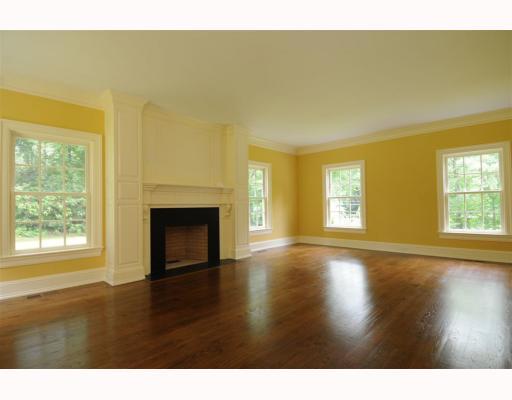 Undisclosed Address Darien, CT 06820 - Photo 3 of 17 a view of an empty room with wooden floor and a fireplace