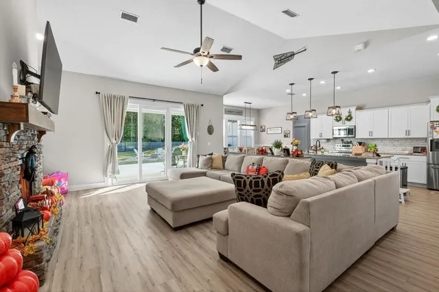 a kitchen with a refrigerator a stove a sink and dishwasher with wooden floor