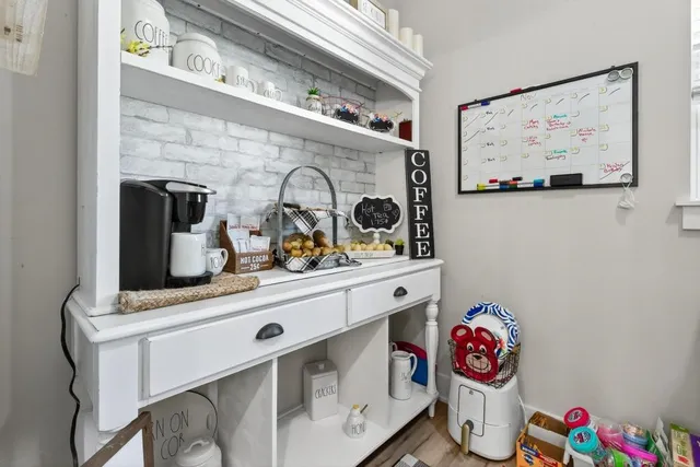 a kitchen with stainless steel appliances granite countertop a sink a stove top oven a counter space and wooden floor