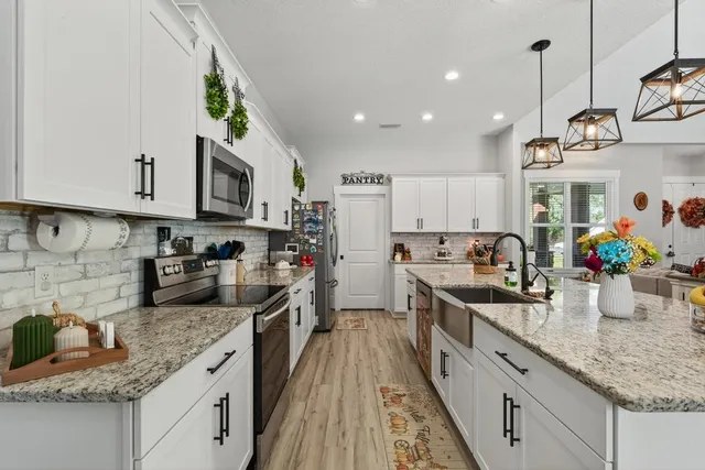 a bedroom with a bed and a flat tv screen on dresser