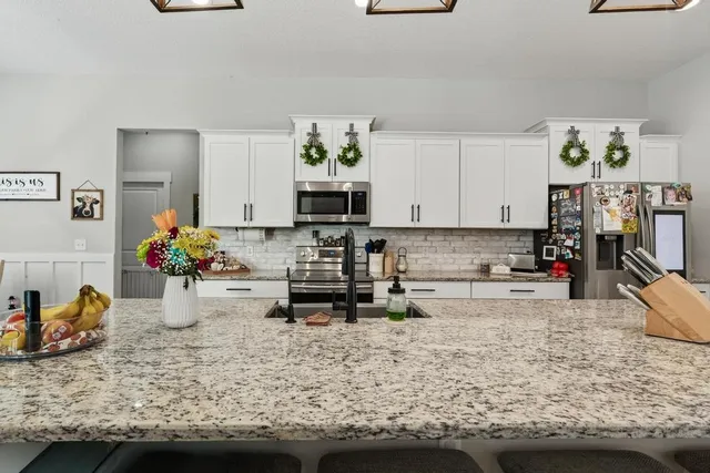 a bathroom with double vanity sinks a vanity and a mirror
