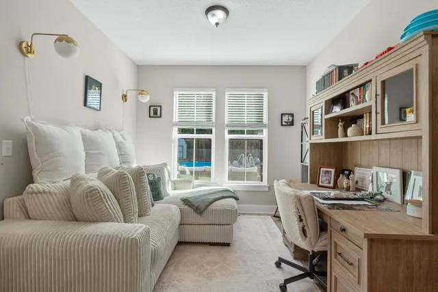 a bedroom with furniture and a flat screen tv