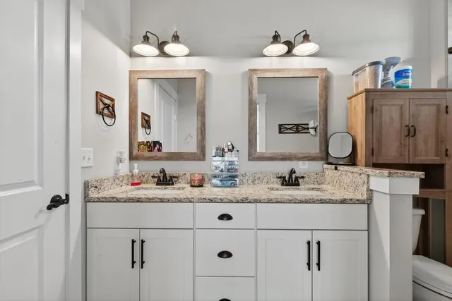 a bathroom with a tub sink and mirror