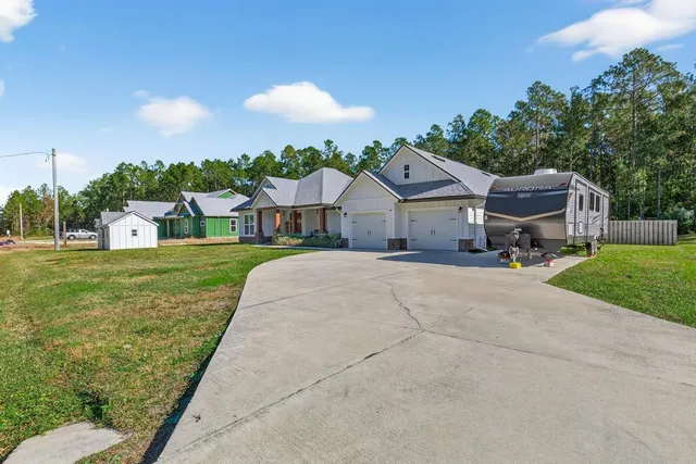 a front view of a house with a yard and porch