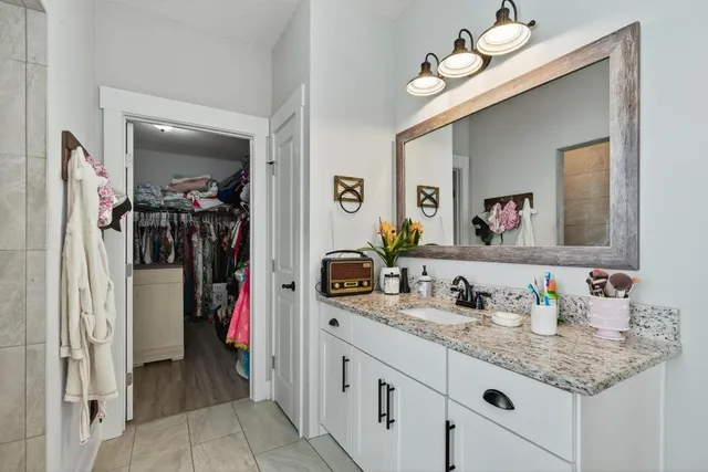 an aerial view of residential houses with outdoor space and trees