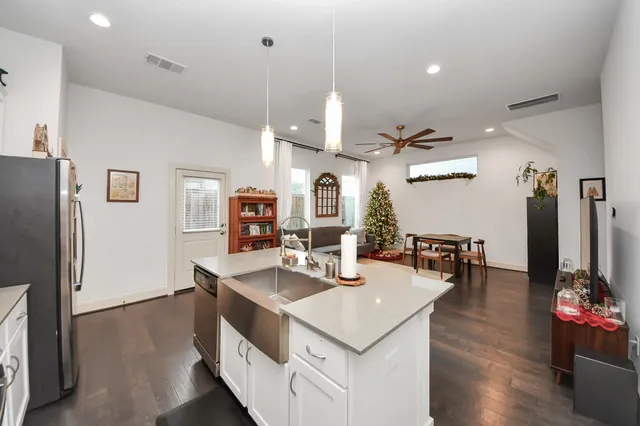 a kitchen with a sink a counter top space and stainless steel appliances