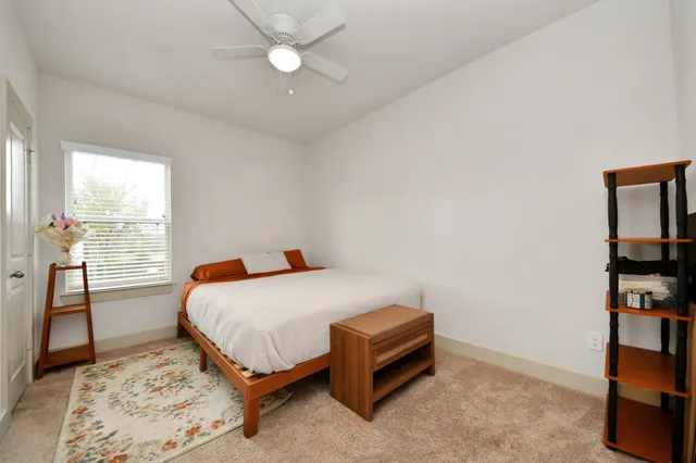 a bedroom with a bed and a book shelf