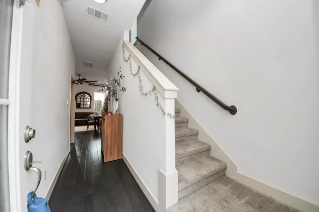 a view of entryway and hall with wooden floor