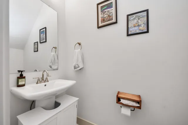 a bathroom with a sink mirror and toilet