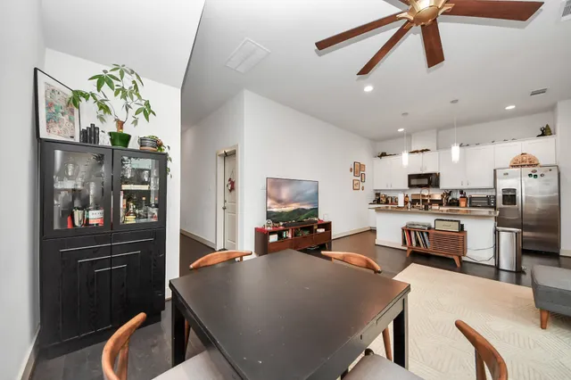 a living room with stainless steel appliances kitchen island granite countertop furniture and a view of kitchen