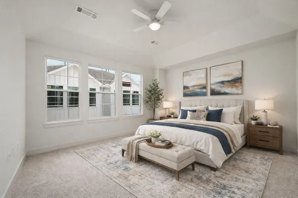 a bedroom with a large bed and a window