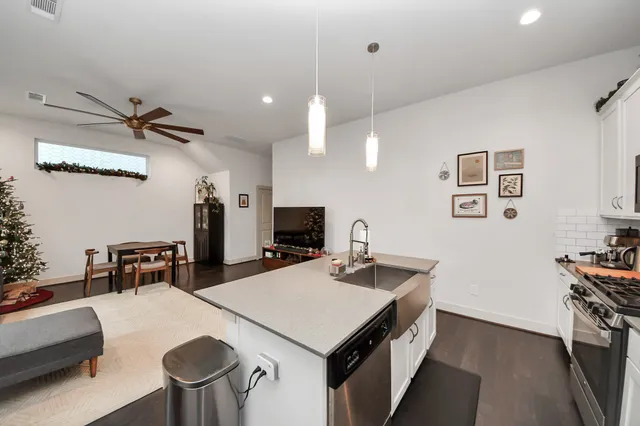 a kitchen with a stove a refrigerator and a dining table