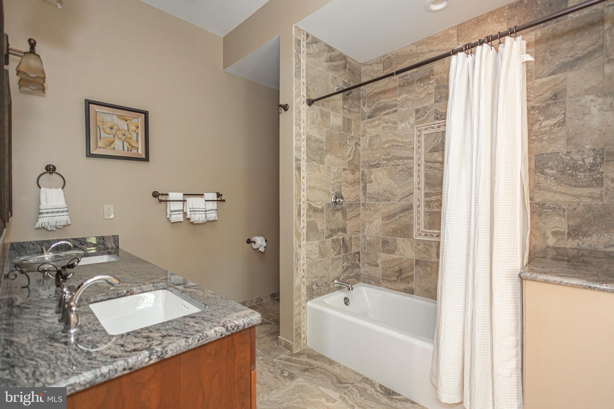 992 A Worthington Mill Road Newtown, PA 18940 - Photo 65 of 96 a bathroom with a granite countertop sink a mirror a bathtub and shower