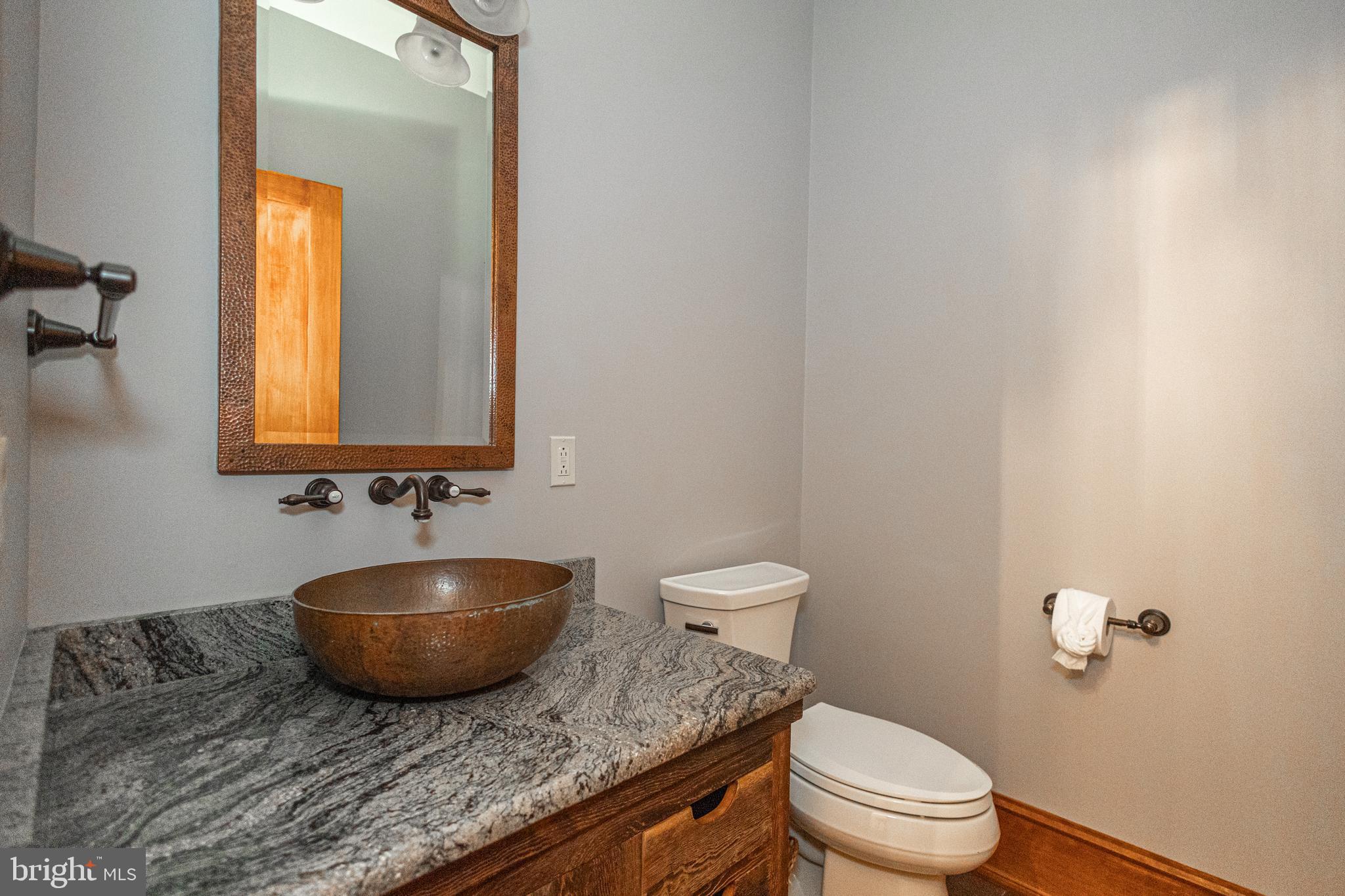 992 A Worthington Mill Road Newtown, PA 18940 - Photo 66 of 96 a bathroom with a granite countertop toilet a sink and mirror