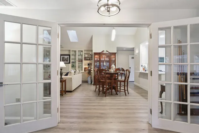 a dining room with furniture and wooden floor